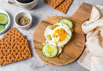 Healthy crispbread breakfast. Whole wheat with cream cheese, cucumbers and egg.  Whole Grain Crispbread for low calory diet.
