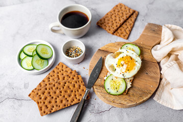 Healthy crispbread breakfast. Whole wheat with cream cheese, cucumbers and egg.  Whole Grain Crispbread for low calory diet.