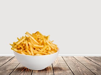 Tasty fast food French fries in plate