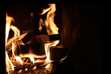 Burning bars of wood in a sauna stove