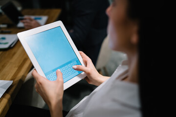 Crop businesswoman with tablet in office