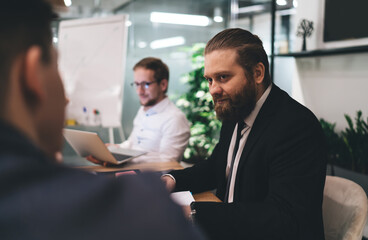 Male colleagues at conference in office