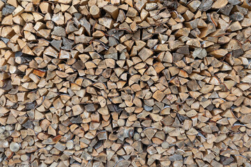 Stack of chopped firewood prepared for heating house at winter time