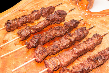 delicious meat skewer, on the table, made on fire