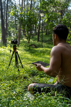 Hispanic Latino Man Giving Class, While Being Recorded By A Camera, Holding Ipad Or Tablet In His Hand, Mexico