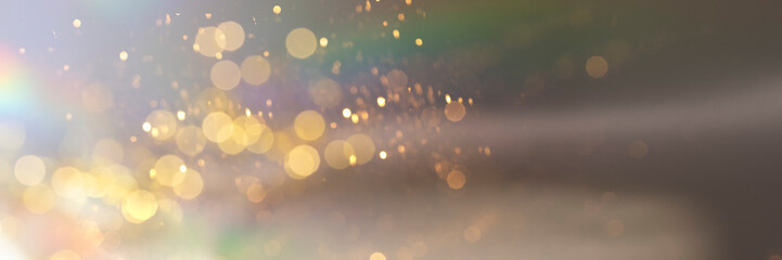 Abstract holographic background with golden sparklees and bokeh. Festive banner backdrop