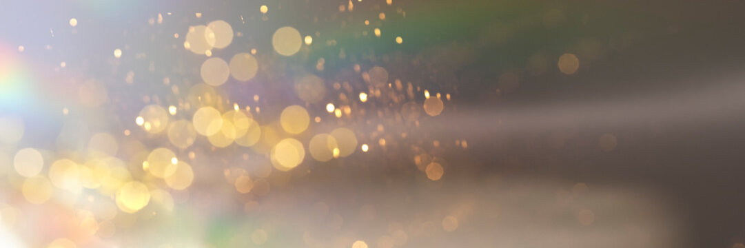 Abstract holographic background with golden sparklees and bokeh. Festive banner backdrop