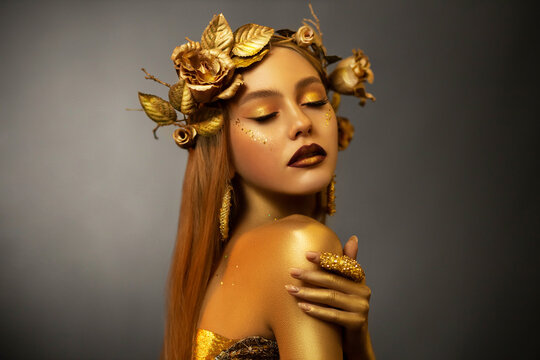 Fantasy portrait woman autumn greek goddess. golden skin body. Girl queen in wreath crown flowers gold roses. Sexy face metal glitter art makeup. Artistic photo. Girl glamour princess. Fashion model 