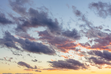 Sunset sky with dark clouds and orange light