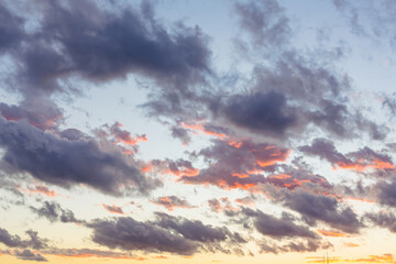 Sunset sky with dark clouds and orange light