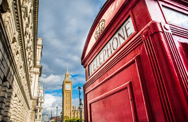 red phone box in front of Big Ben