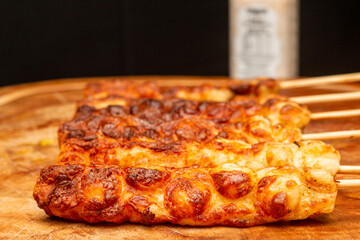 delicious cheese kebab, baked cheese, on the table, made in the fire
