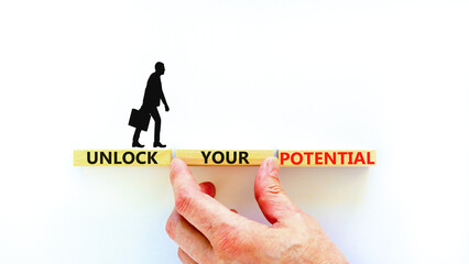 Unlock your potential symbol. Concept words Unlock your potential on wooden blocks. Businessman hand. Beautiful white background. Business, psychological unlock your potential concept. Copy space.