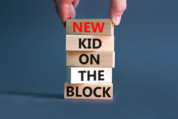 New kid on the block symbol. Concept words New kid on the block on wooden blocks. Businessman hand....