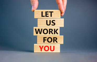 Let us work for you symbol. Concept words Let us work for you on wooden blocks. Businessman hand....