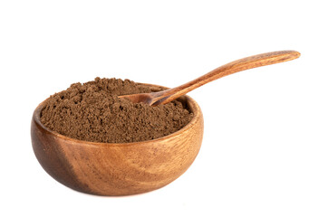 Ground cinnamon powder in a wooden bowl on a white background.