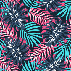 Fashionable seamless tropical pattern with bright plants and leaves on a dark blue background. Beautiful exotic plants.  Print with hand drawn exotic plants.