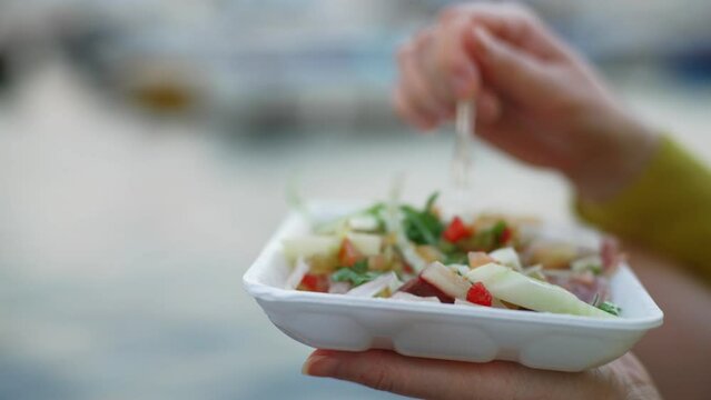 Woman Eating Fresh Bovine offal and intestines cow offal salad.