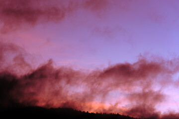 Mountain silhouette at dawn sky with scattered clouds, cold morning in Guatemala, Central America.