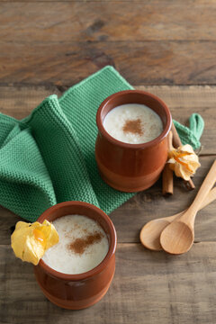Bowls of rice pudding and cinnamon on a wooden background. Copy space. Vertical photo.