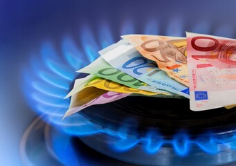 Blue fire on gas burner and paper money