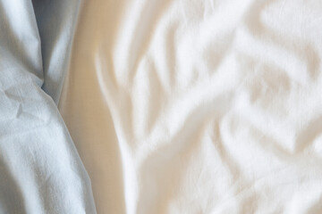 Abstract crumpled linen fabric texture background. Natural light blue hue dyed linen and white...