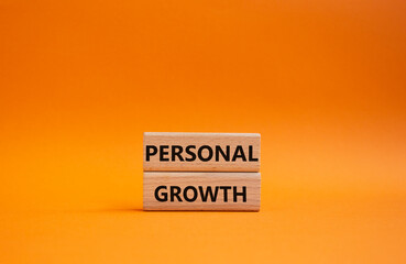 Personal growth symbol. Wooden blocks with words Personal growth. Beautiful orange background. Business and Personal growth concept. Copy space.