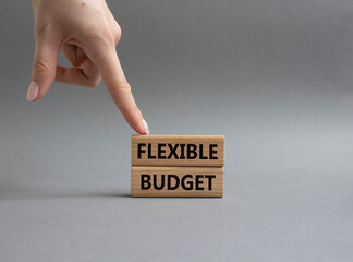 Flexible budget symbol. Concept words Flexible budget on wooden blocks. Beautiful grey background....