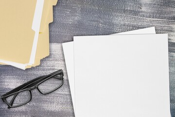Set of blank papers and glasses on the desk
