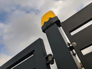 Automatic modern gates against the sky