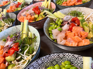 bowls of salad with fresh raw fish and vegetables