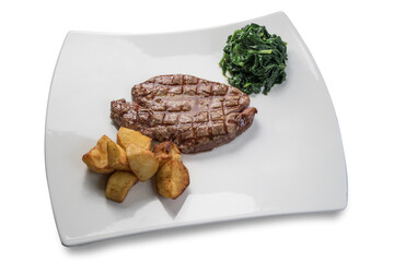 Grilled beef tenderloin steak with spinach and baked potatoes on white plate isolated on white