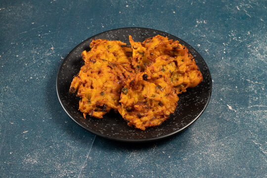 Indian spicy vegetable pakora or pakoda served in dish isolated on table top view