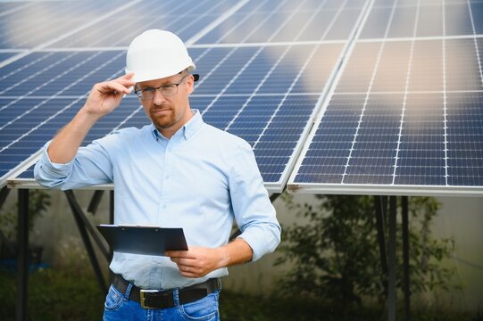 Engineer At Solar Power Station With Solar Panel. Practical Lessons On Renewable Energy Power Plants.