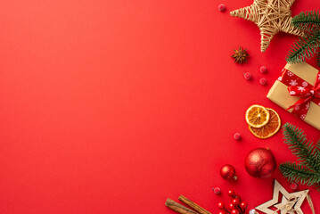 Christmas Eve concept. Top view photo of ornaments baubles fir branches craft paper giftbox wicker star dried orange slices mistletoe berries cinnamon on isolated red background with copyspace - obrazy, fototapety, plakaty
