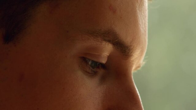 Young man eye and part of face on a green background. Pavel, my right eye. Date of shooting day 13 July 2022 year, MSK time. This video was filmed in Russia.