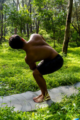 mexican man doing yoga and stretching in the forest, mexico