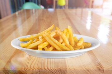 Tasty fast food French fries in plate