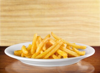 Tasty fast food French fries in plate