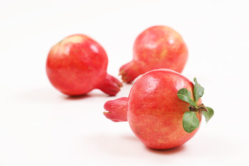 Red ripe pomegranate on a white background. Shallow depth of field