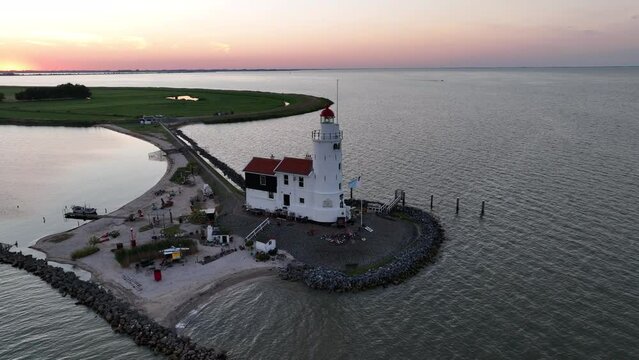 Cinematic 4k aerial video of setting sun at the Paard van Marken lighthouse at the Markermeer in the Netherlands