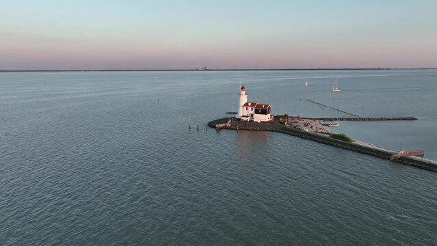 Cinematic 4k aerial video of setting sun at the Paard van Marken lighthouse at the Markermeer in the Netherlands