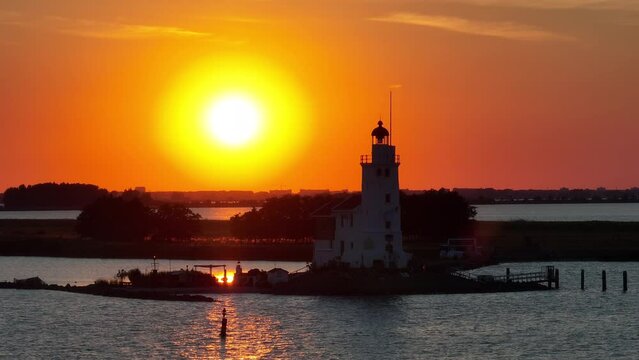 Cinematic 4k aerial video of setting sun at the Paard van Marken lighthouse at the Markermeer in the Netherlands