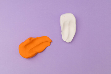 Children's bright plasticine lies on a purple background