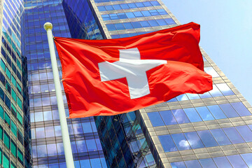 Waving in the wind flag Switzerland on the background of a modern building. Concept of politics,...