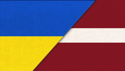 Flag of Ukraine and Latvia. Ukrainian and Latvian flags on fabric surface.