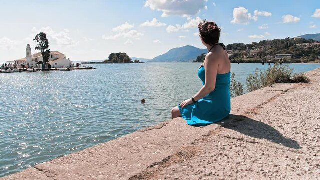 Woman Sits, Pier Corfu Airport Plane Spotting Spot Admires The Weather
