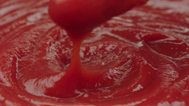 hand passing chicken nuggets in ketchup in slow motion