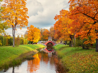 The Cross Bridge in autumn. Golden autumn in Catherine Park, Tsarskoye Selo. Old city park with...
