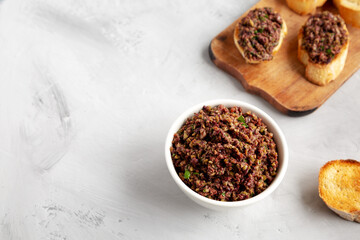 Homemade Mixed Olive Tapenade in a Bowl, side view. Copy space.